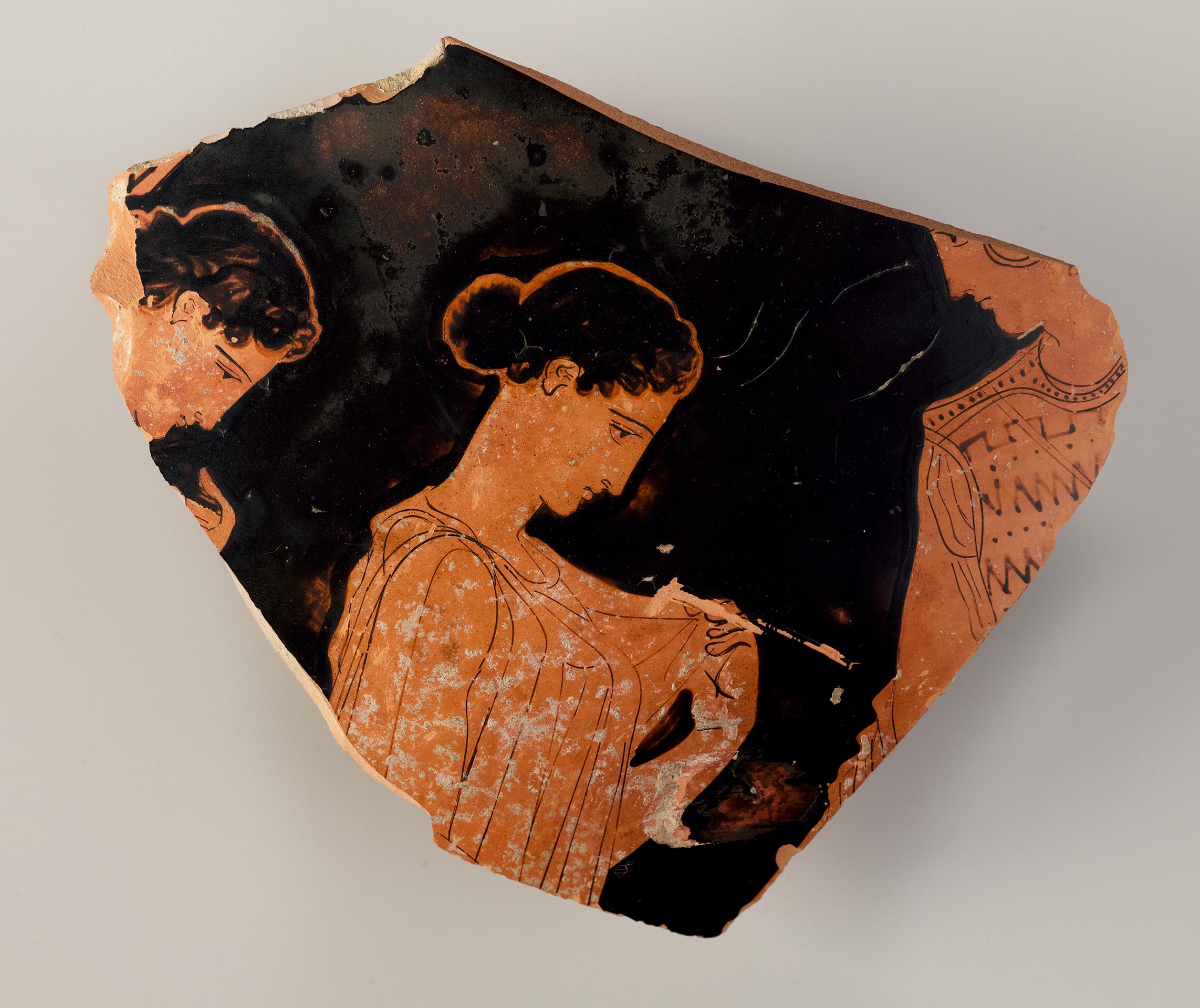 A fragment from a pot depicting a woman