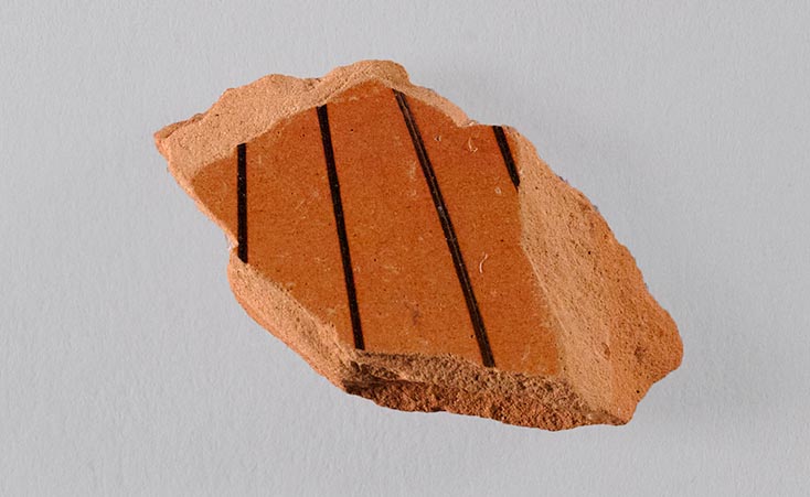 One fragment from the rim of a vase, showing painted decoration
