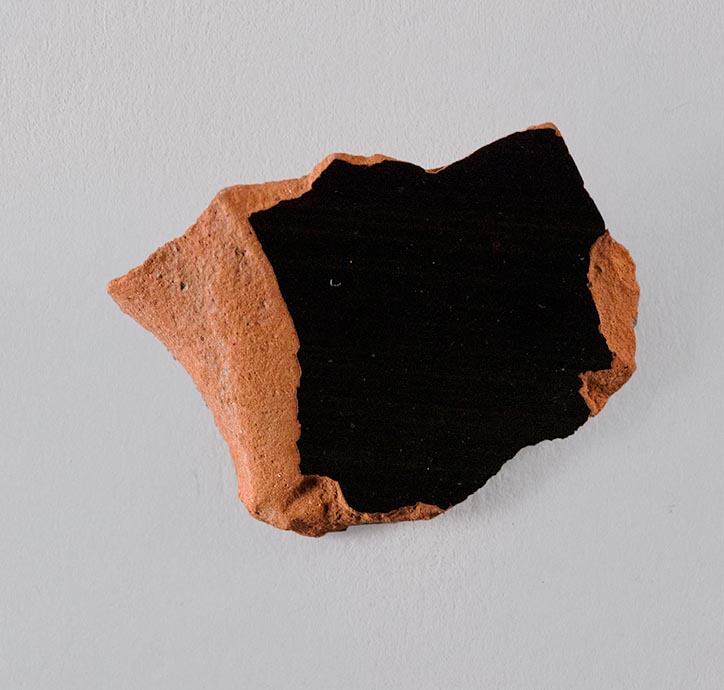 One fragment from the body of a vase, fired black