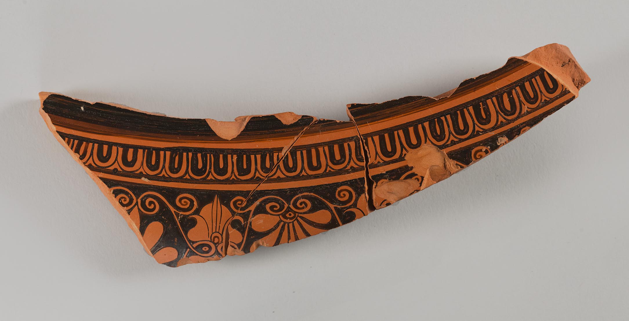 One view of a fragment from a vase, showing painted decoration