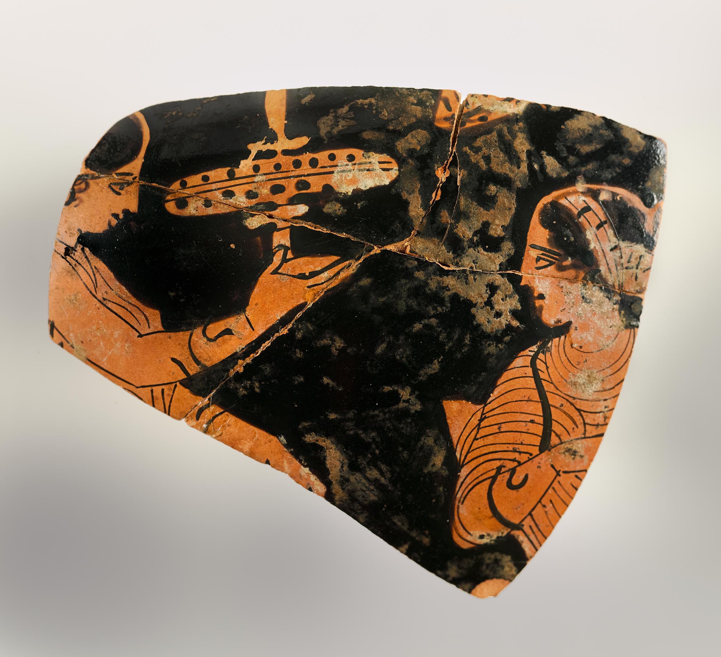 One view of a fragment from a vase, showing the heads and upper bodies of two women