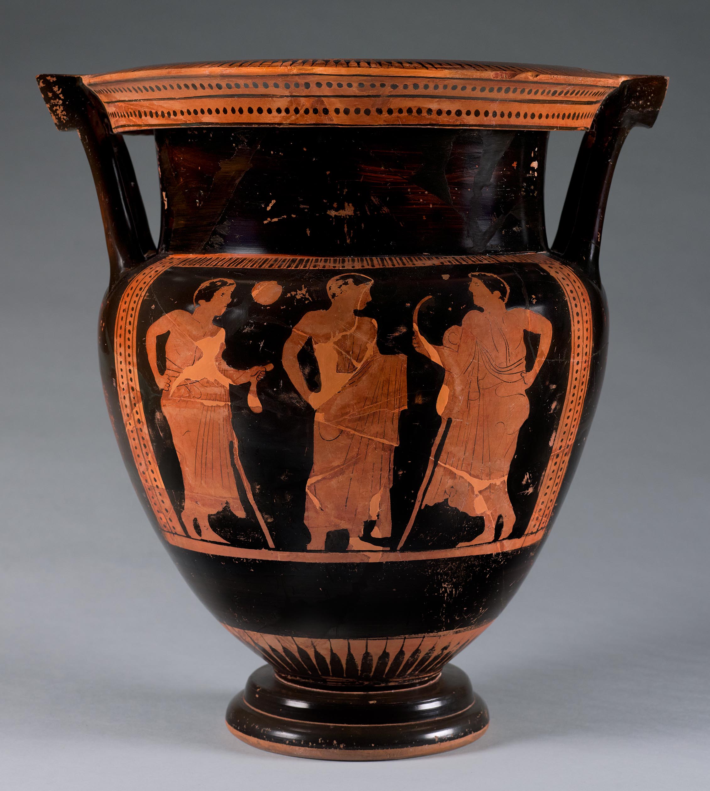 Another view of the vase, the body depicting three beardless mantle figures