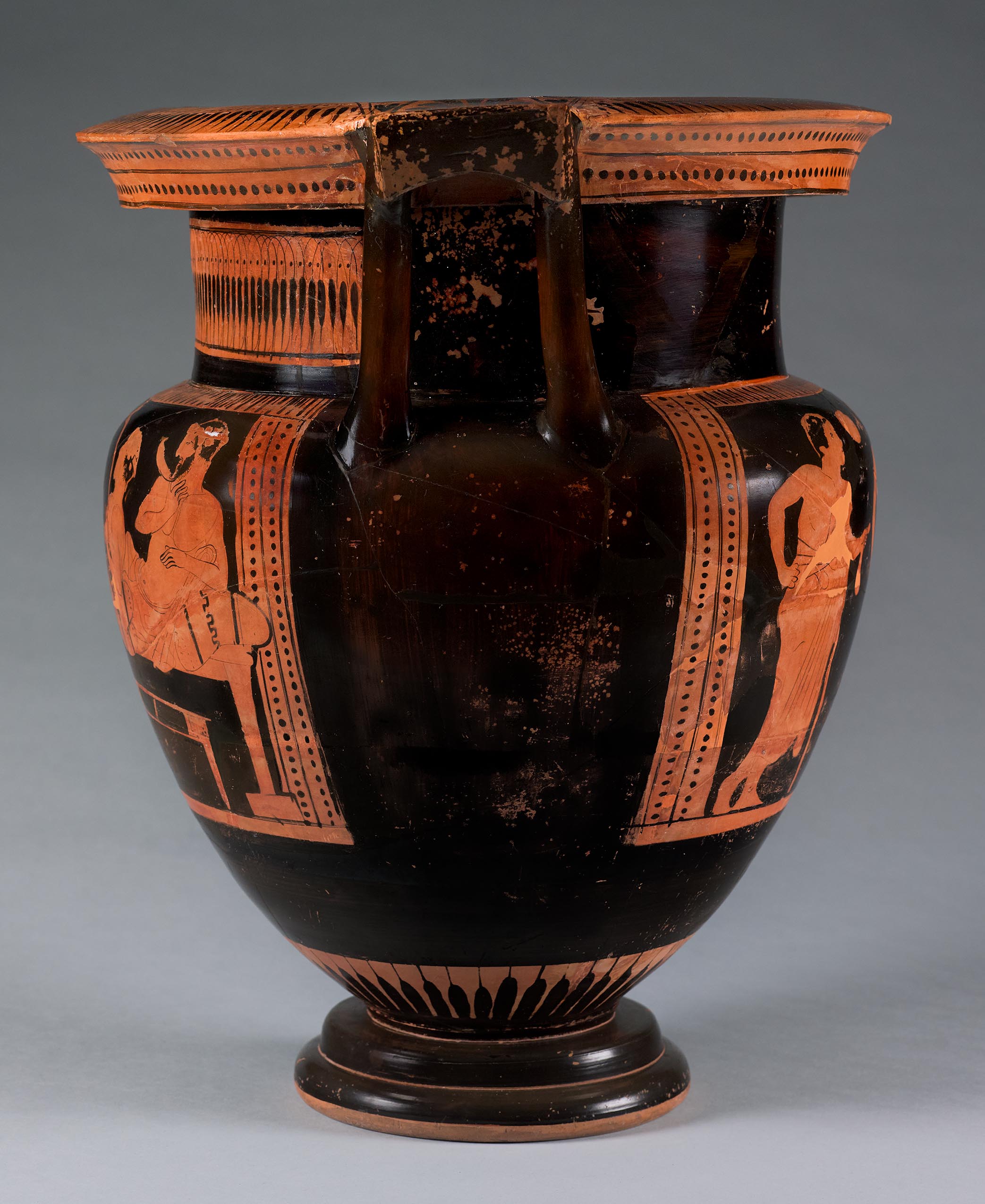 Side view of the vase, showing some decoration and partial figures on the right side 