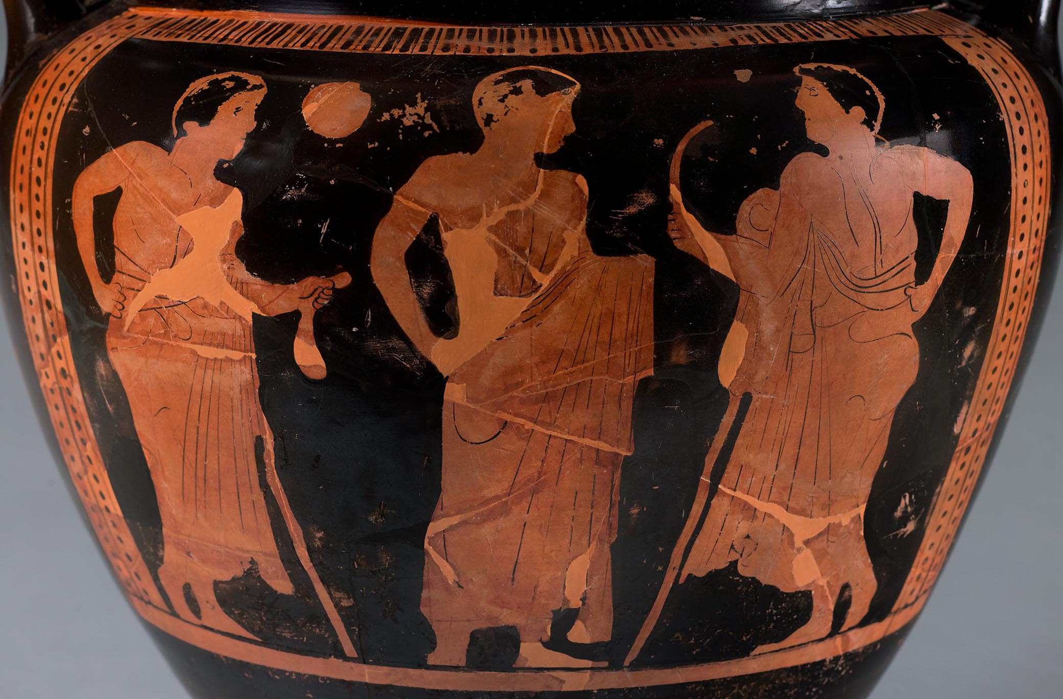 Detail showing the three beardless mantle figures