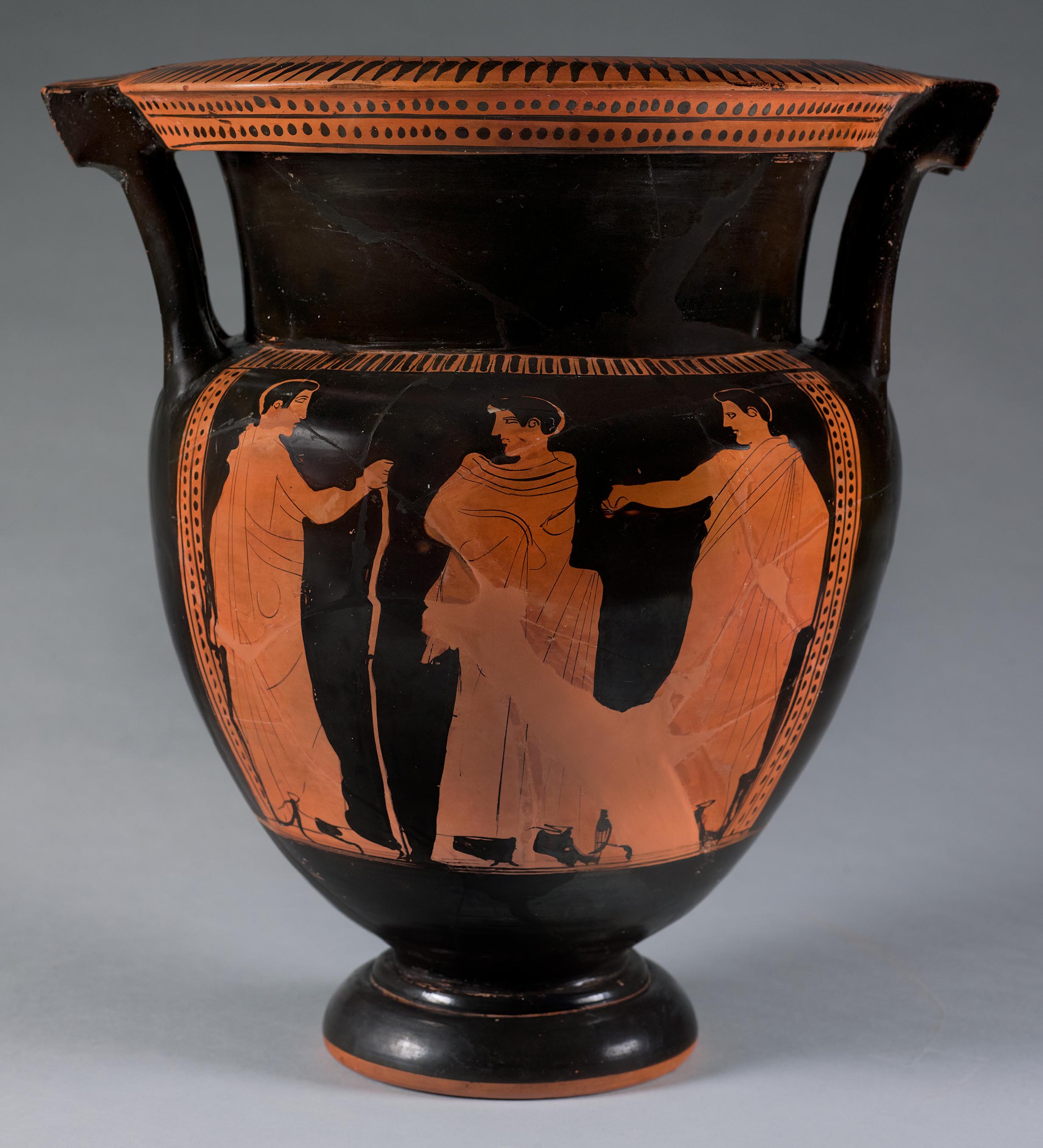 Another view of the vase, showing three beardless mantle figures