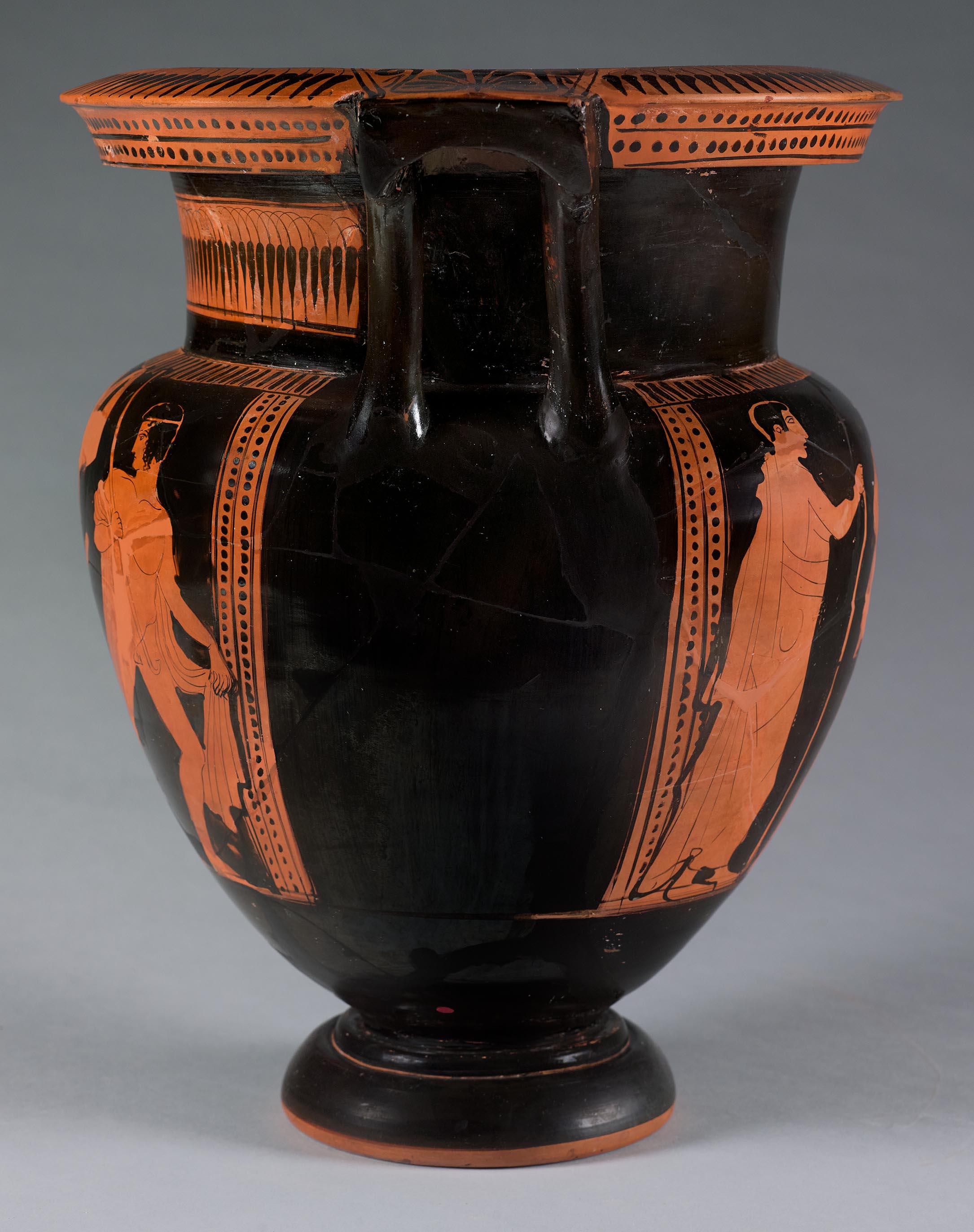 Side view of the vase, showing some decoration and partial figures on the right side 