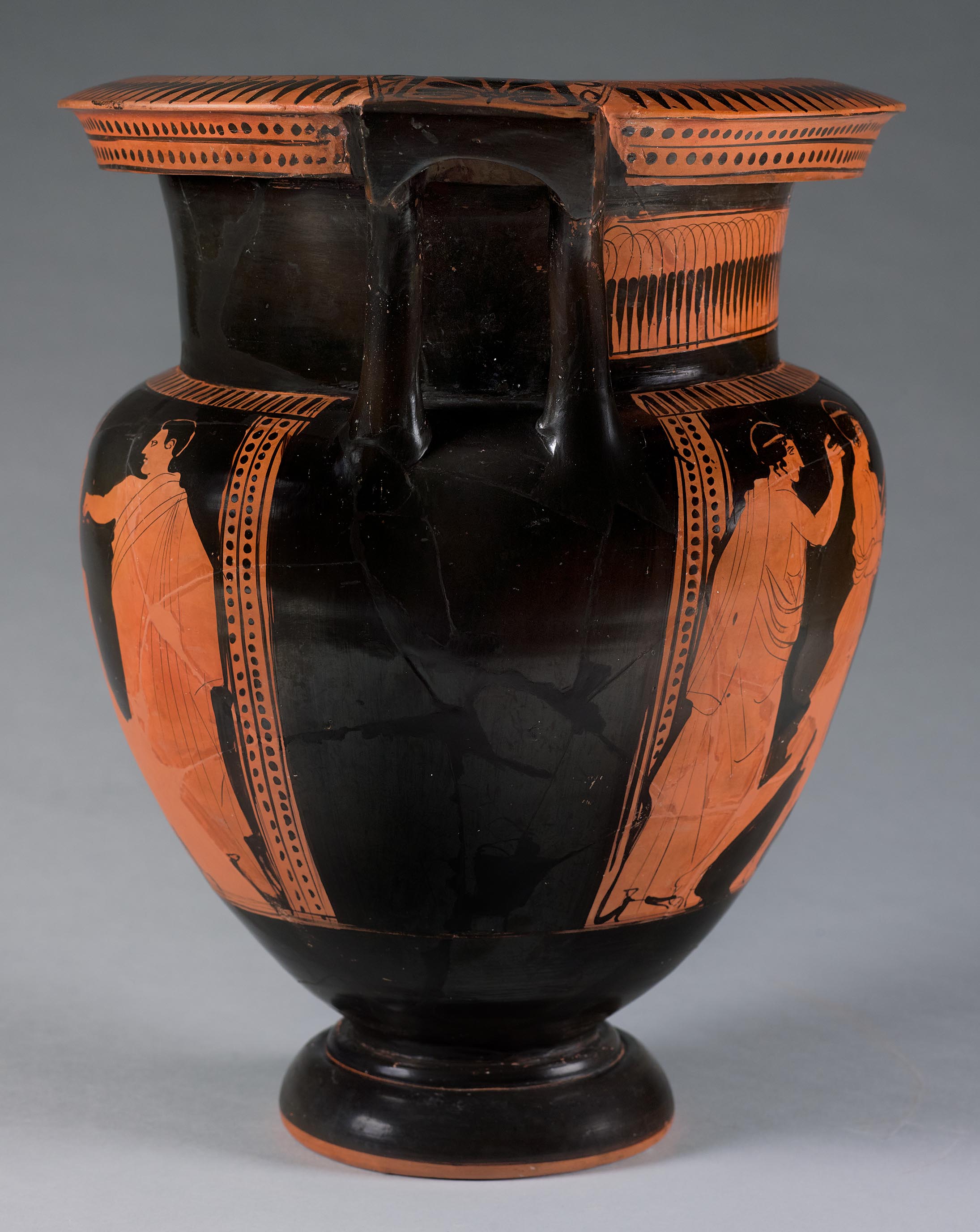 The other side of the vase, showing some decoration and partial figures on the left side