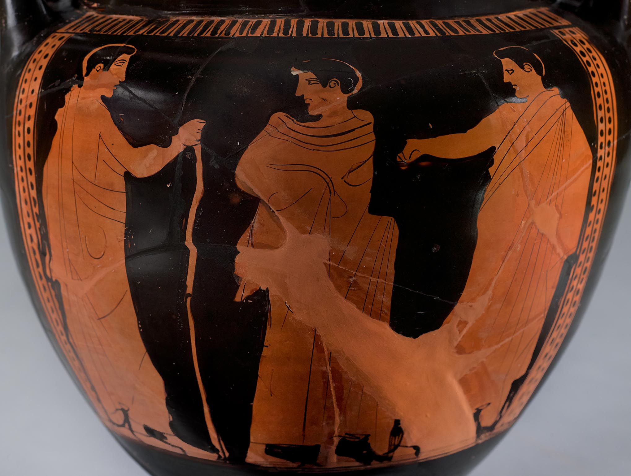 Detail showing the three beardless mantle figures
