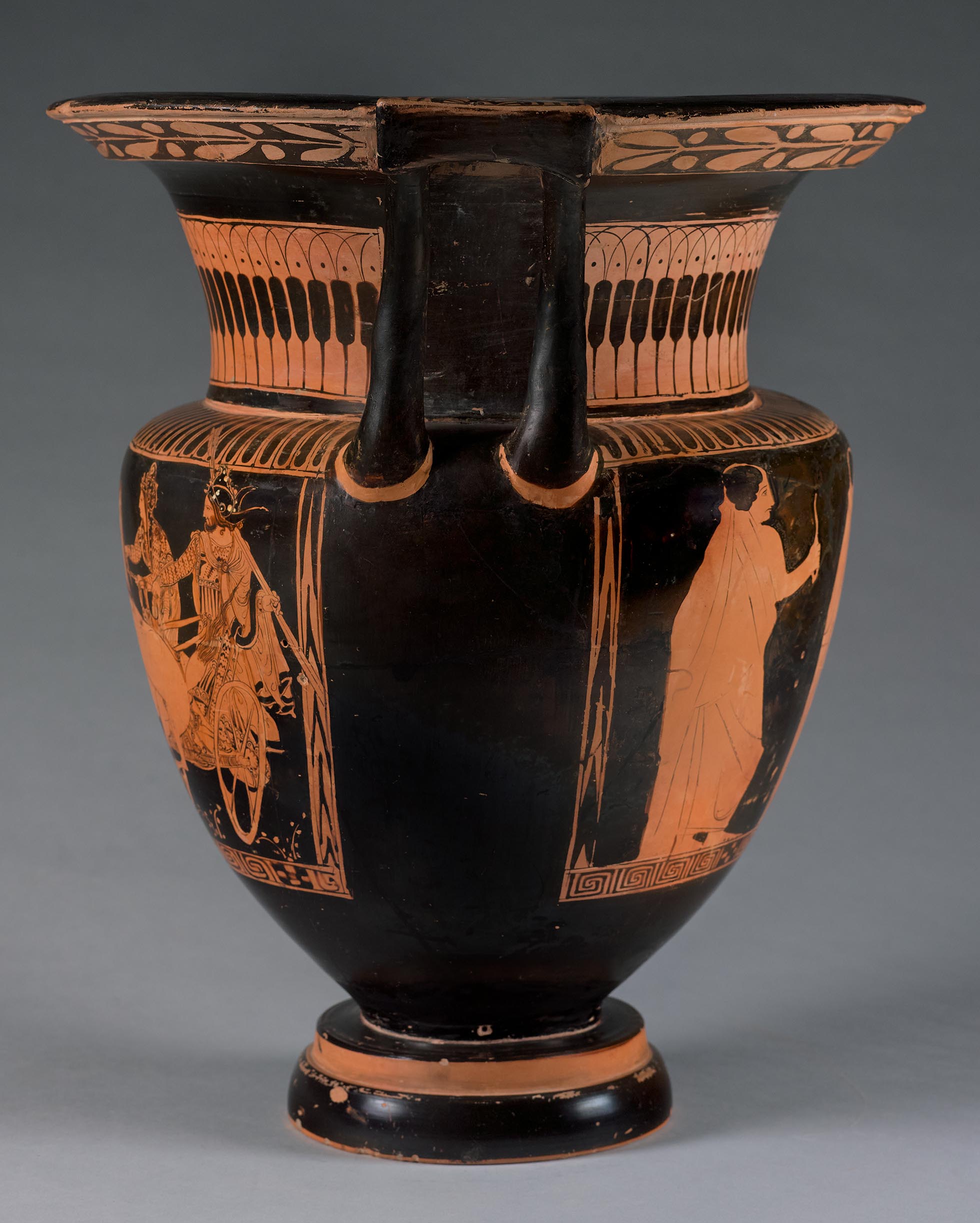 Side view of the vase, showing some decoration and partial figures on the right side 