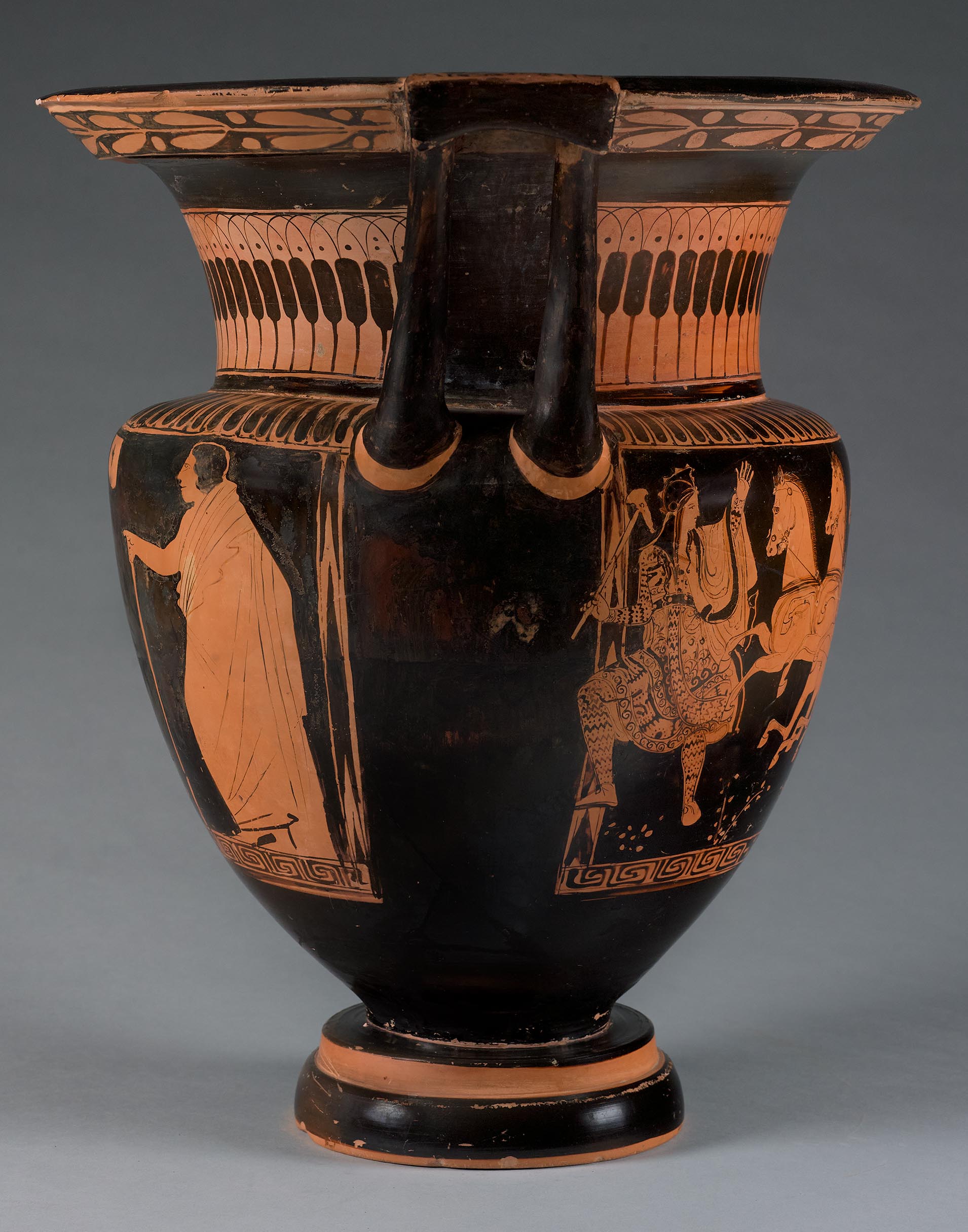The other side of the vase, showing some decoration and partial figures on the left side