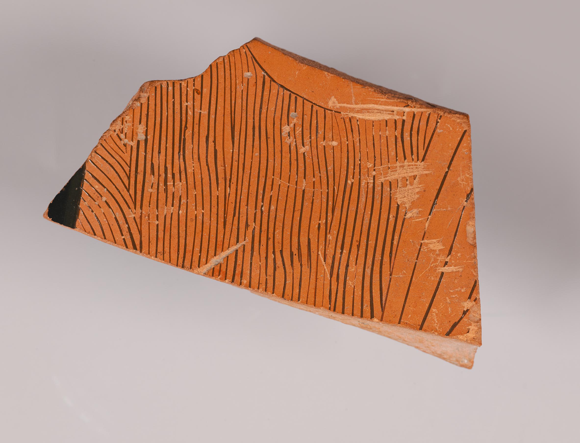 One fragment from a krater, depicting the torso of a woman