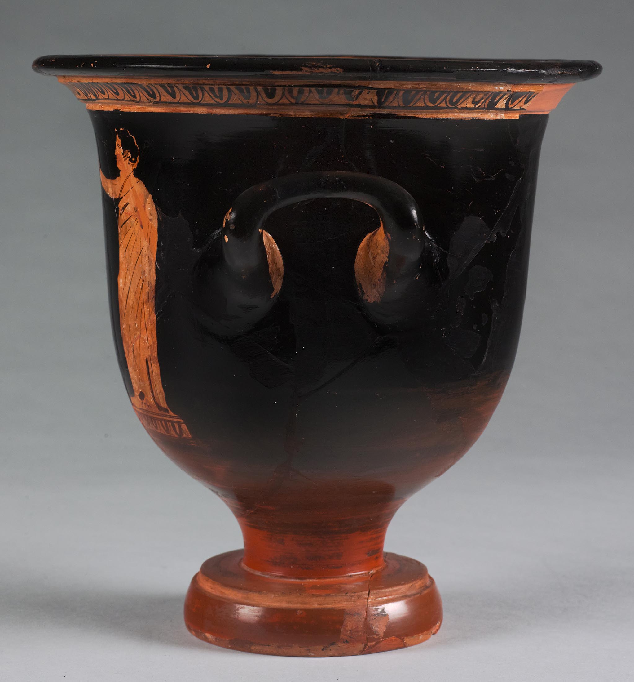 Side view of the vase, showing some decoration and partial figures on the right side 