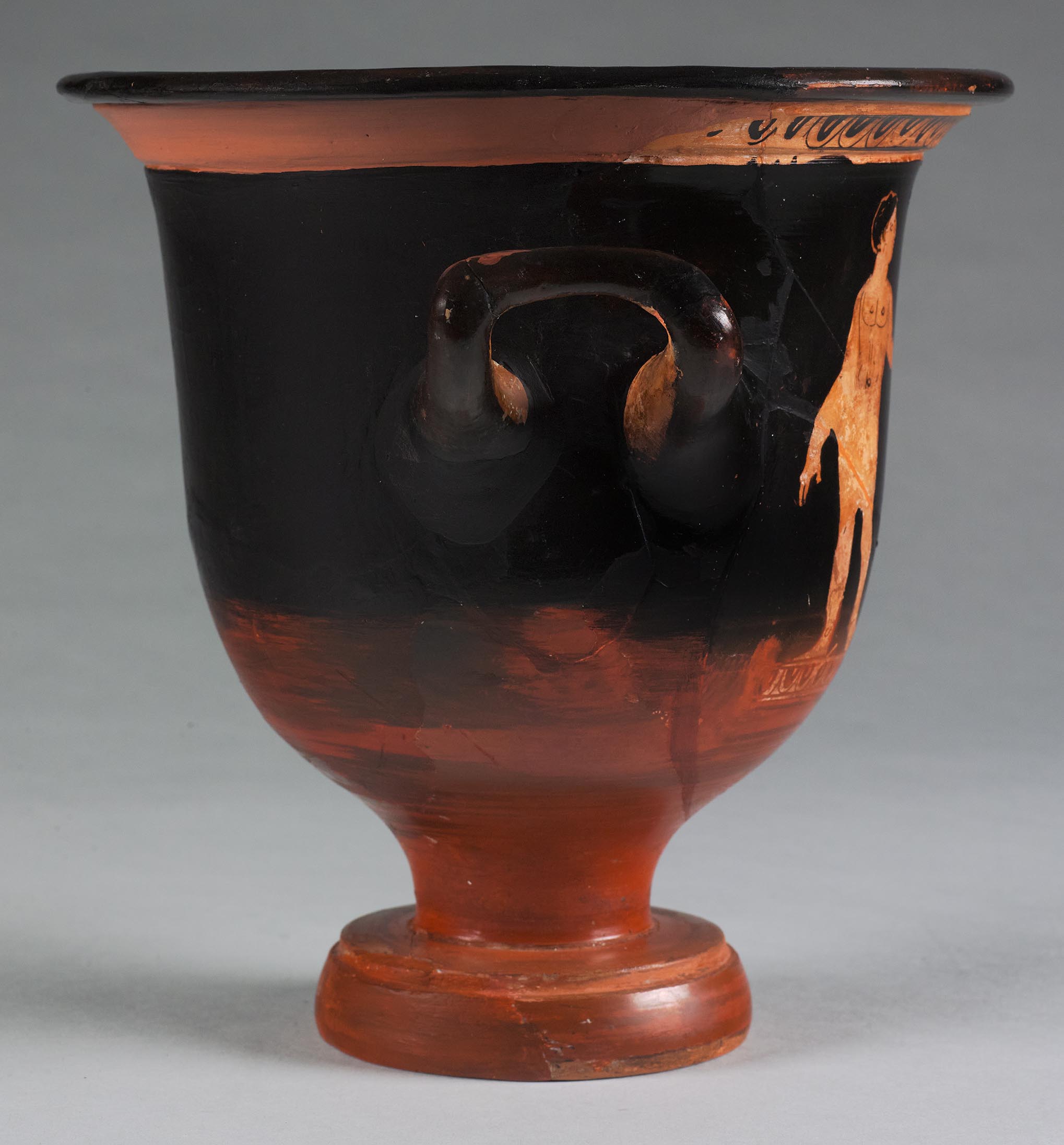 The other side of the vase, showing some decoration and partial figures on the left side