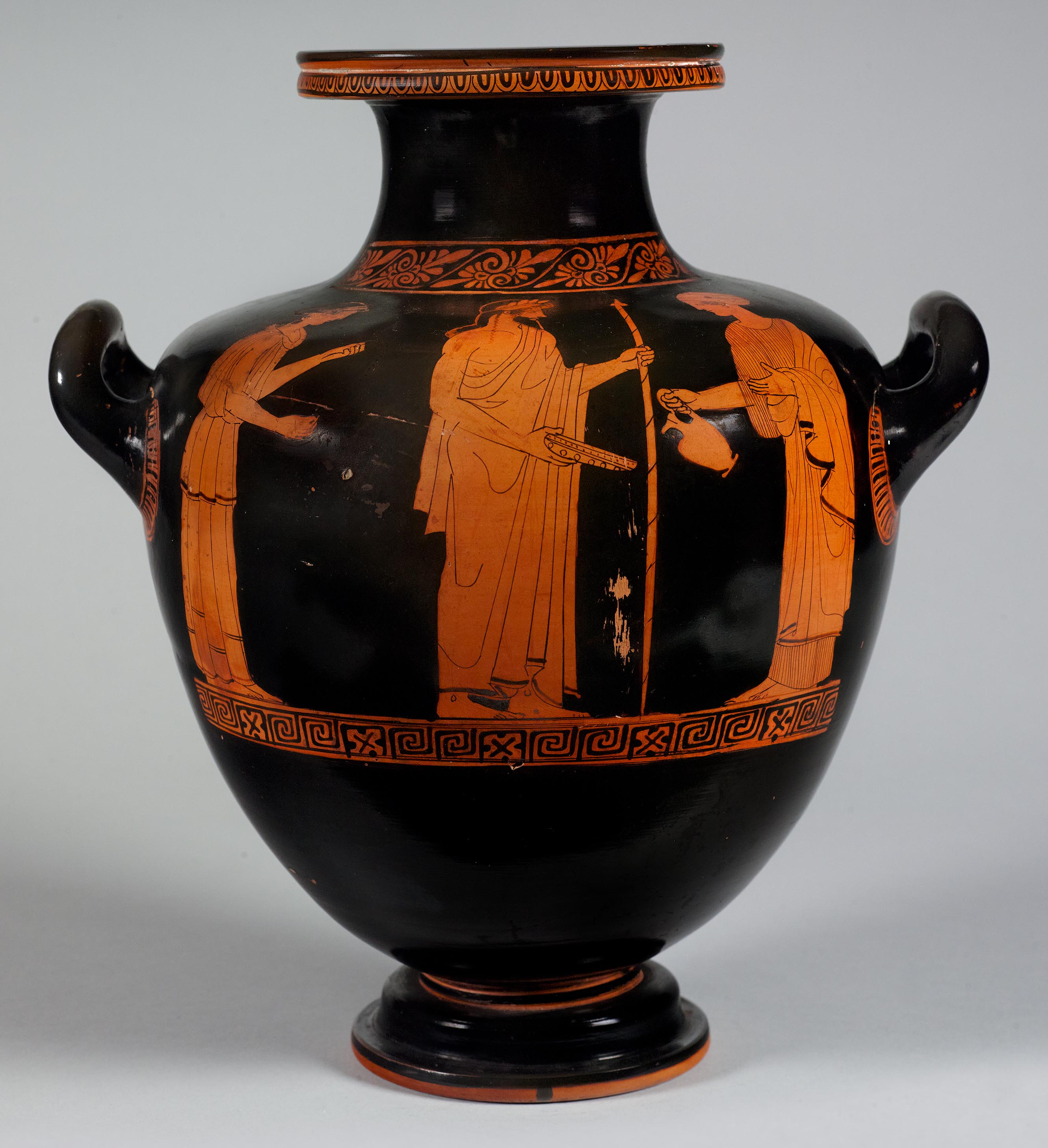 One view of a vase, the body depicting three figures in a libation scene