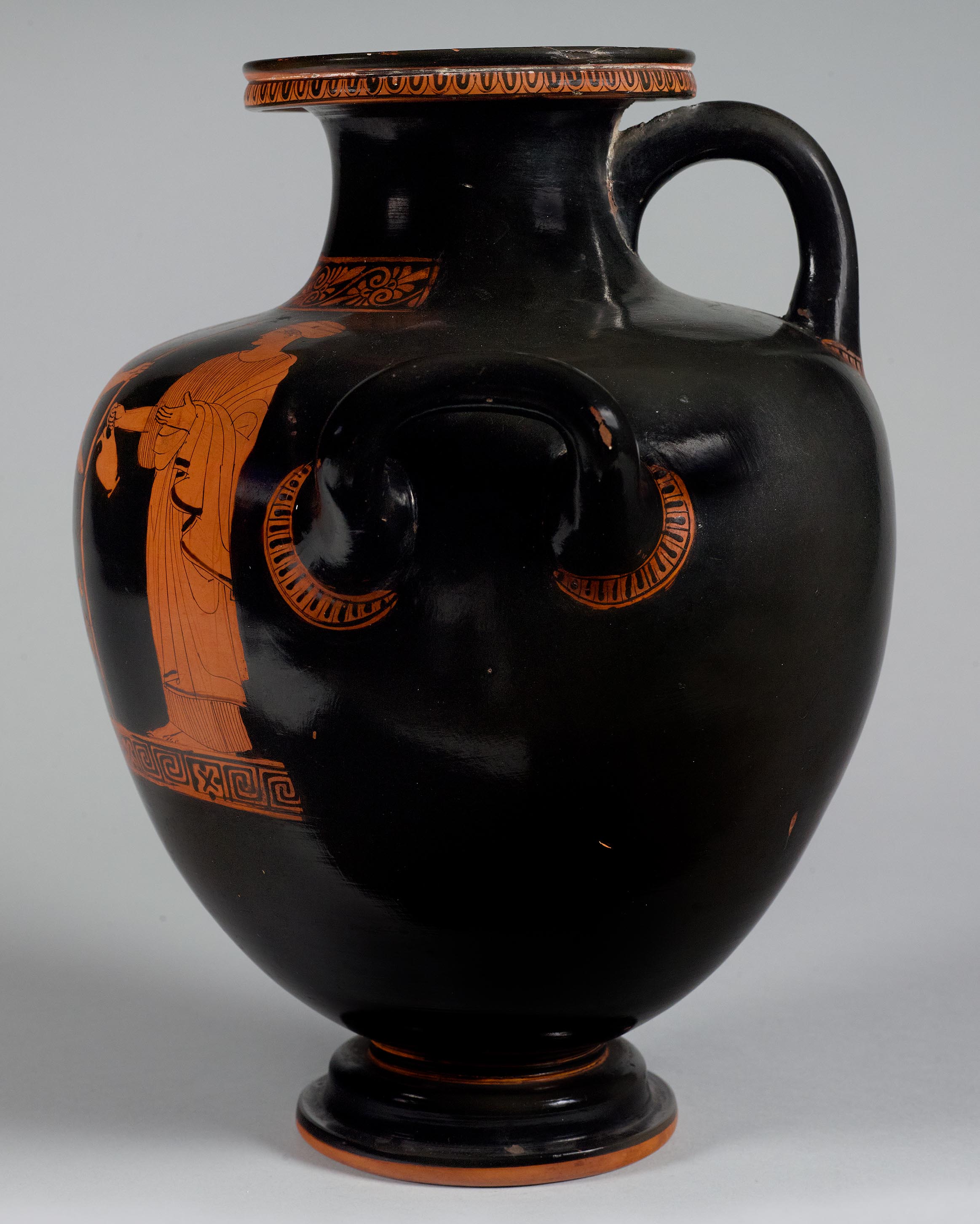 Side view of the vase, showing some decoration and partial figures on the right side 