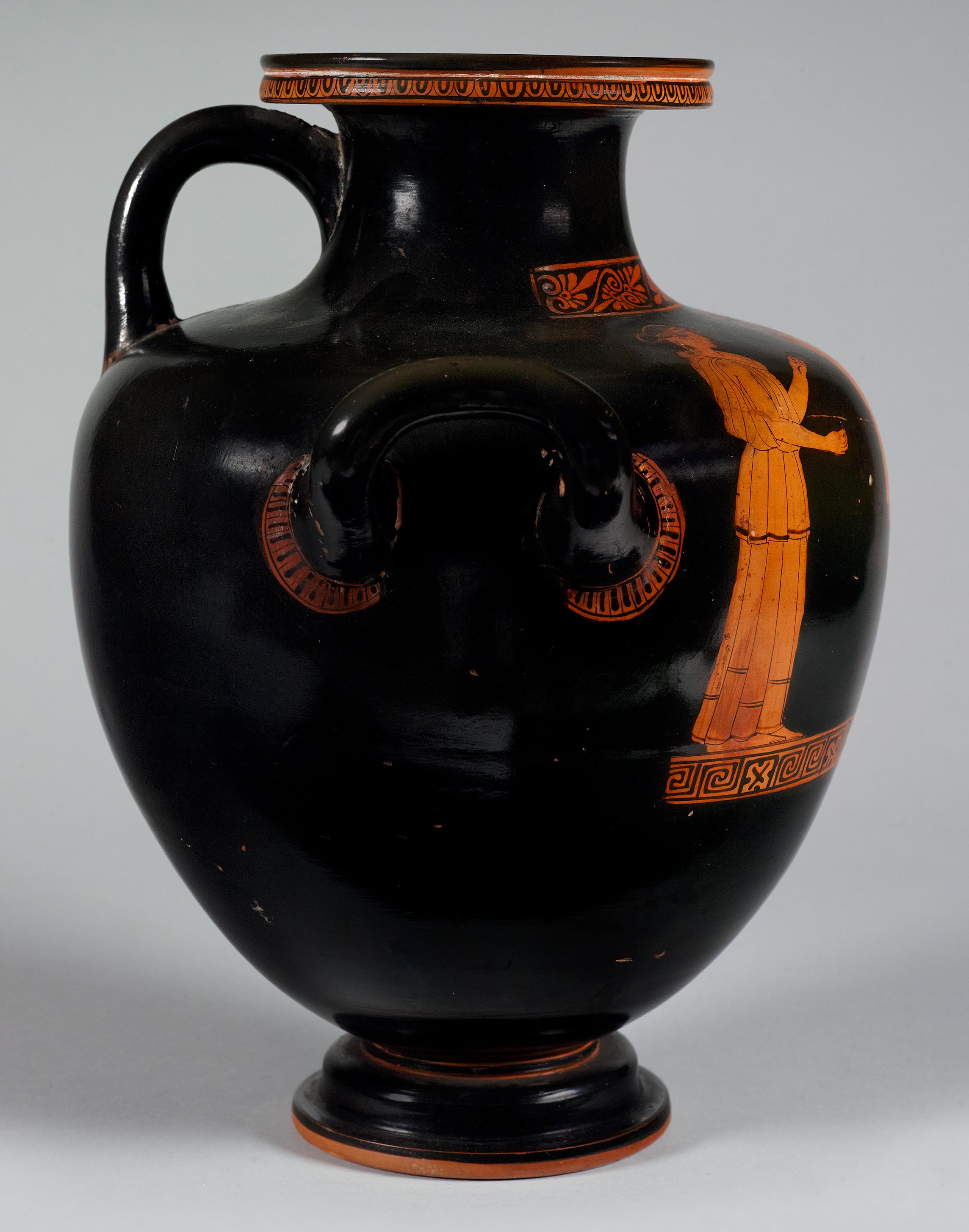 The other side of the vase, showing some decoration and partial figures on the left side