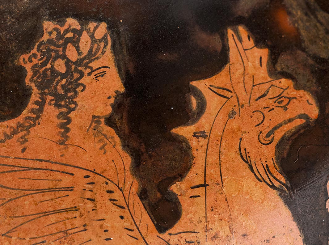 Detail showing the head and bust of Apollo and the head of the griffin