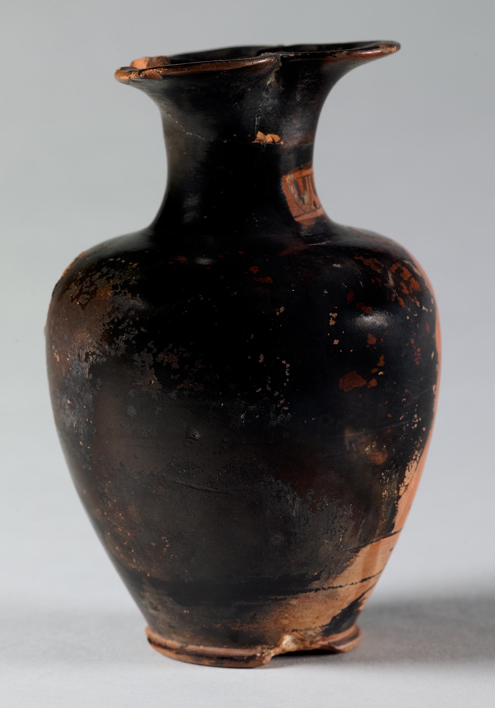 Side view of the vase, showing a partial figure on the left side