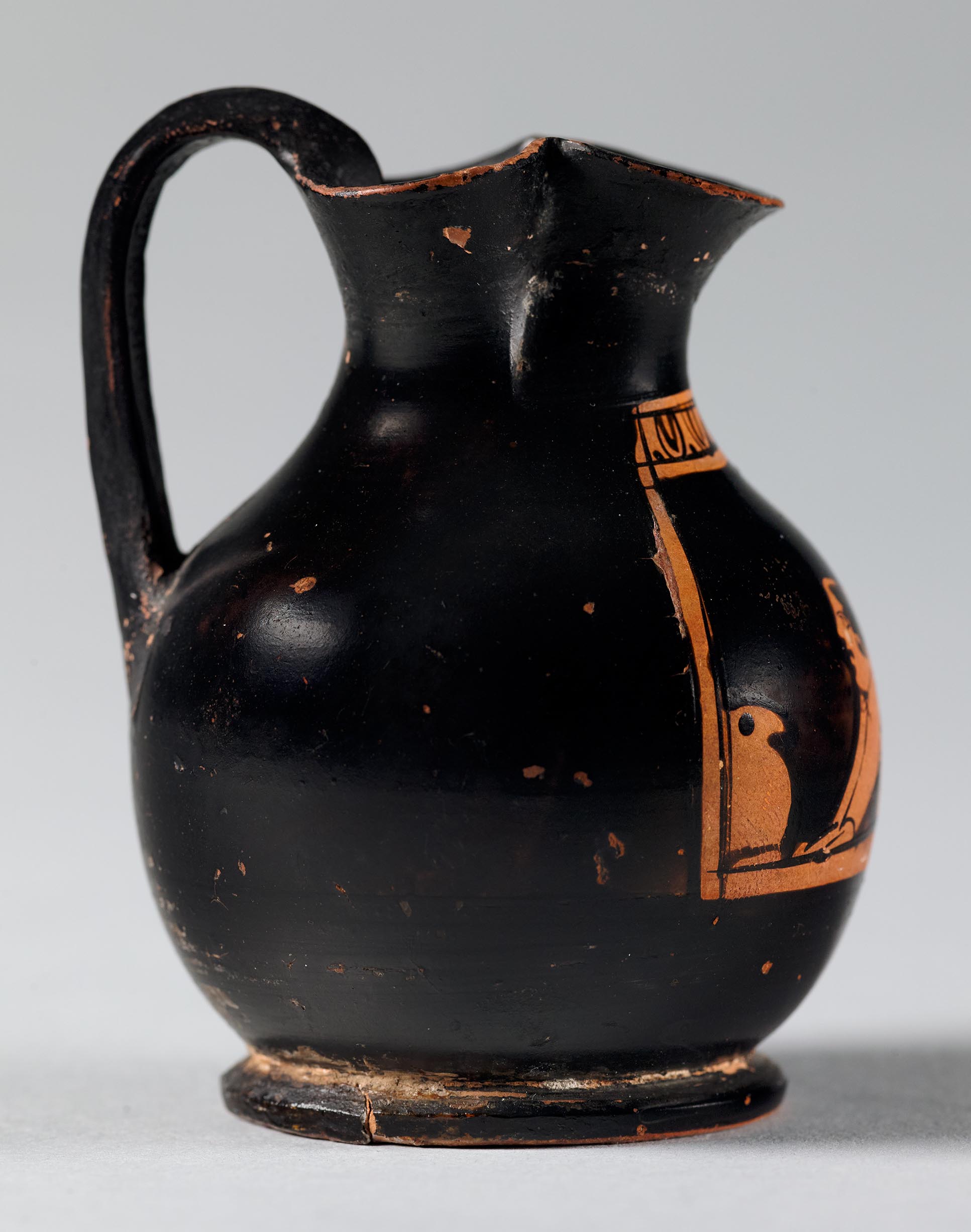 Side view of the vase, showing a partial figure on the left side