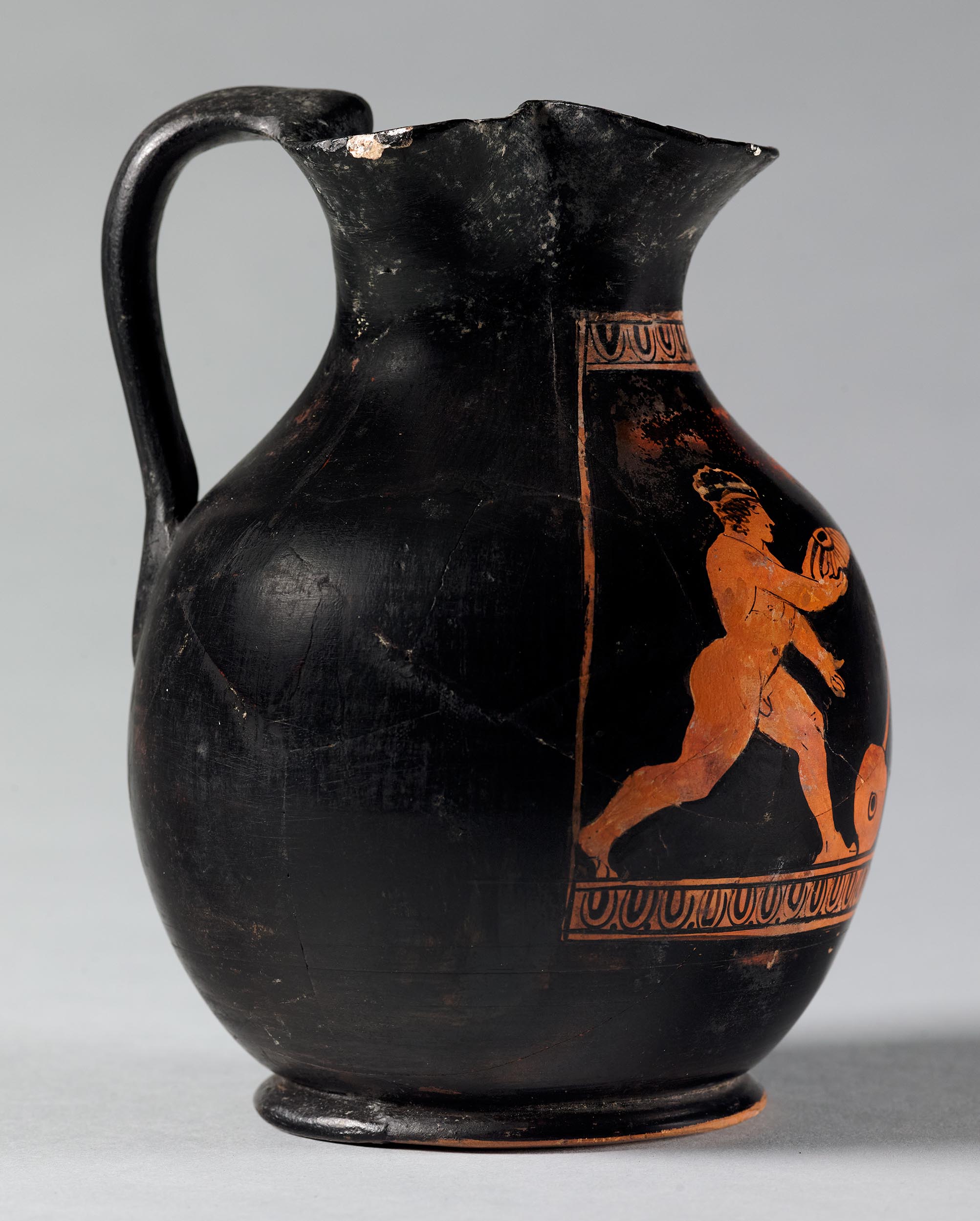 Side view of the vase, showing one figure on the left side
