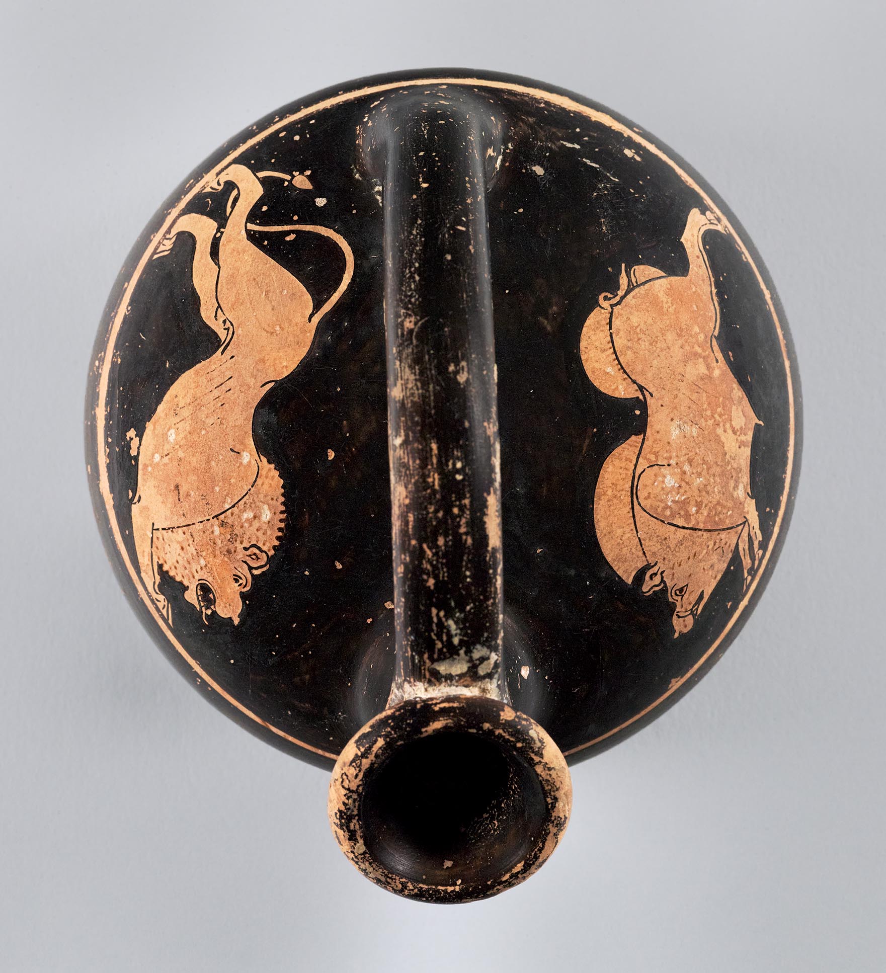 View of a vase from above, the body depicting a lion and a boar