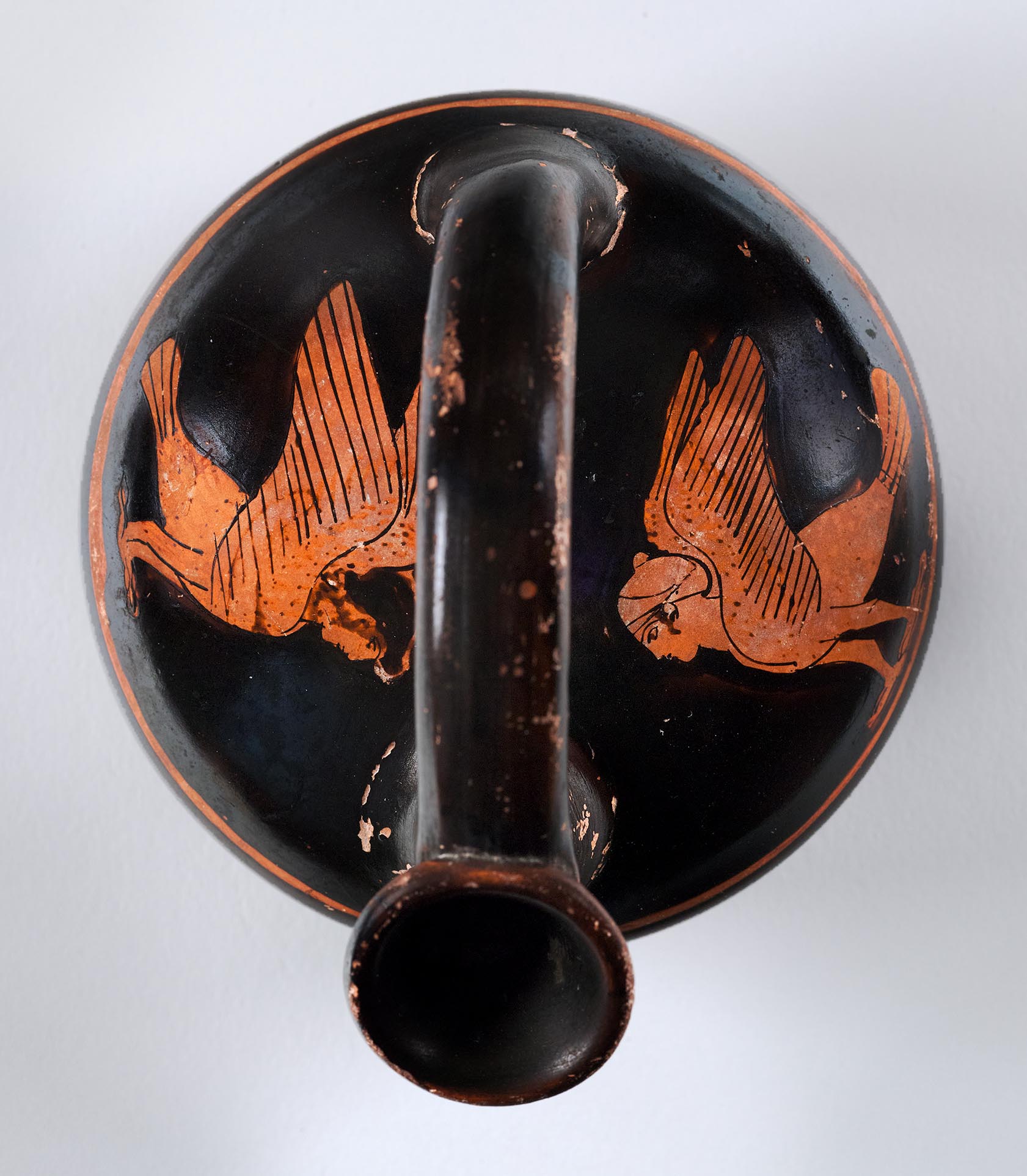 View of a vase from above, the body depicting two sirens
