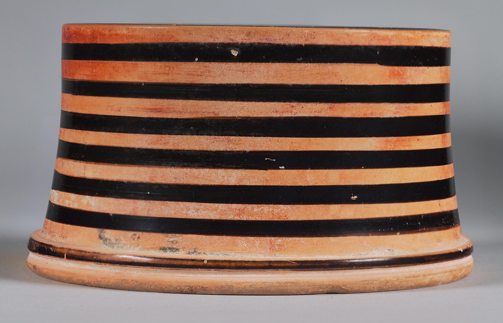View of the striped side of the pyxis