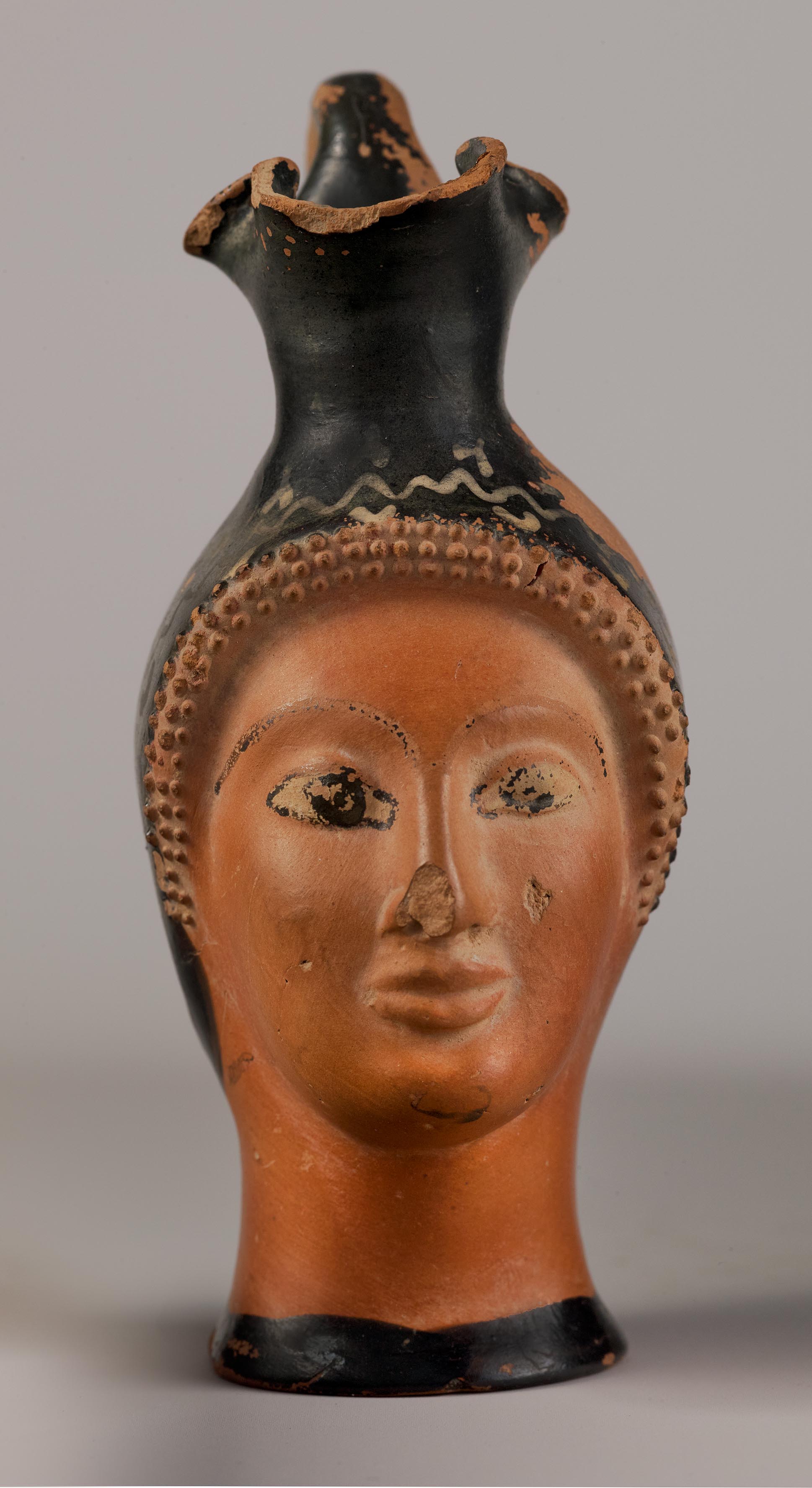 One view of a vase in the form of a female head