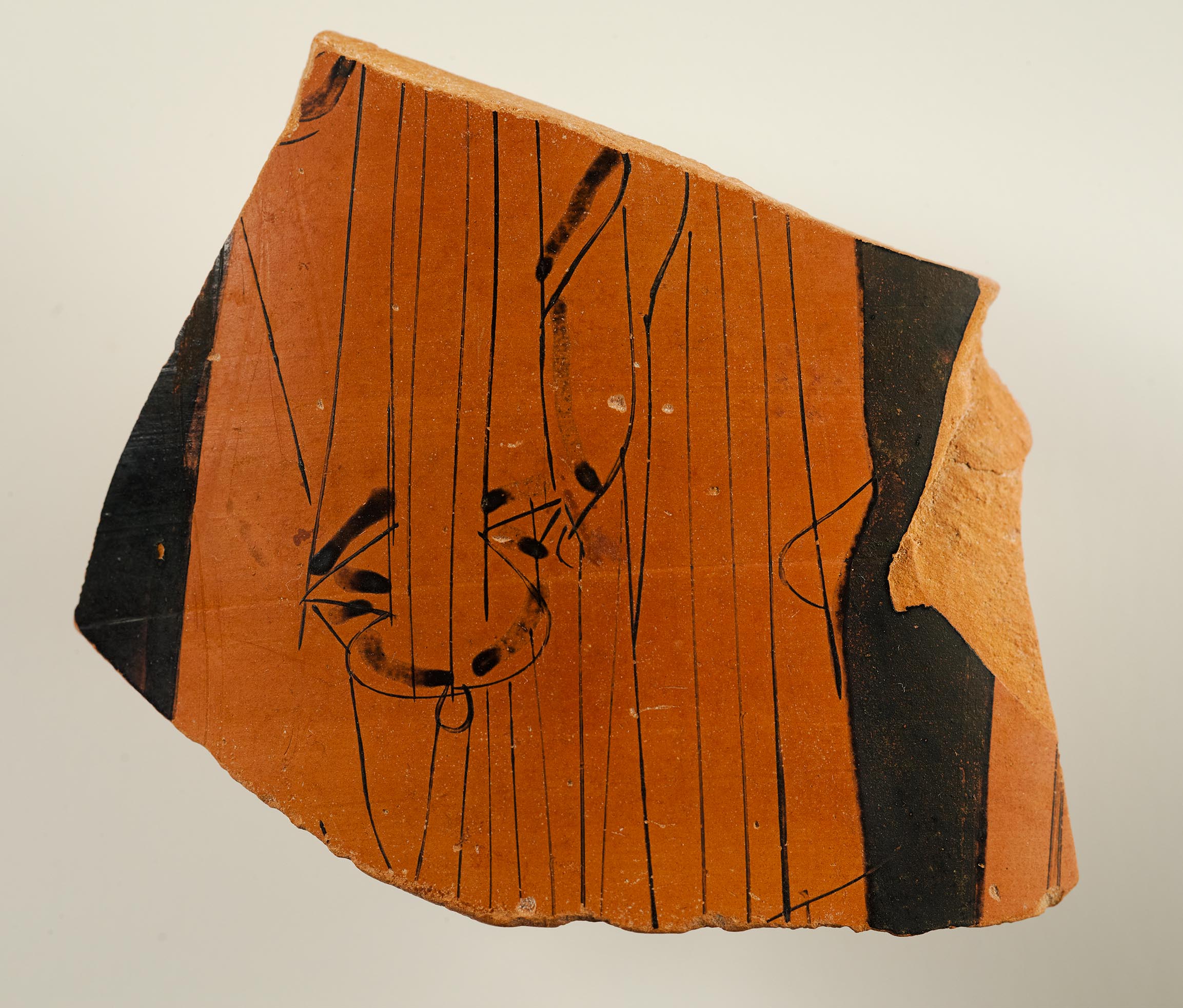 A vase fragment depicting a portion of the draped body of a woman