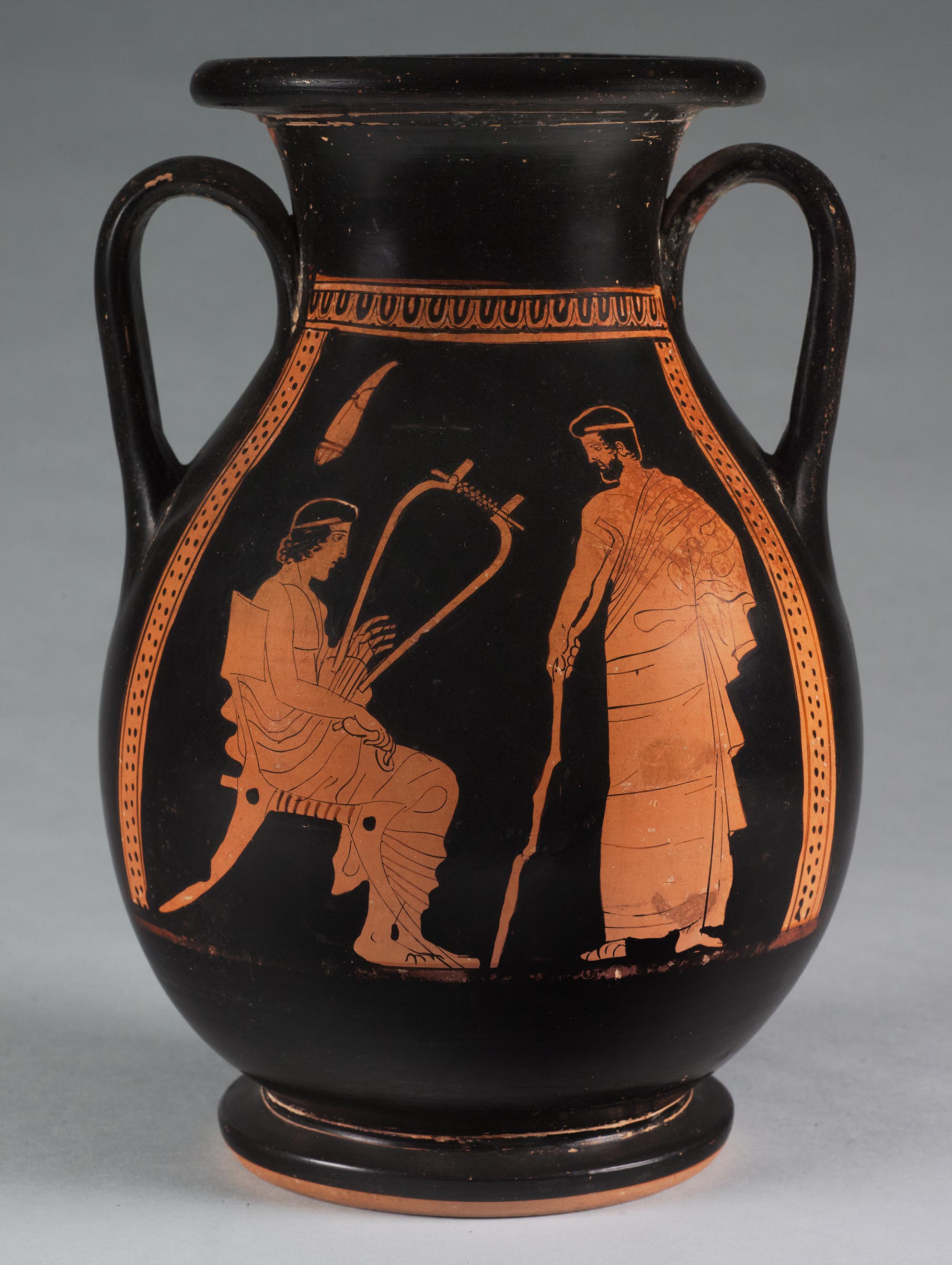 One view of a vase, the body depicting a seated male youth with a *barbitos* and a standing male